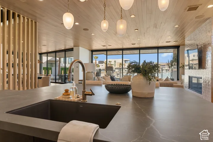Spacious kitchen island with a dark composite sink and a brushed gold-tone faucet