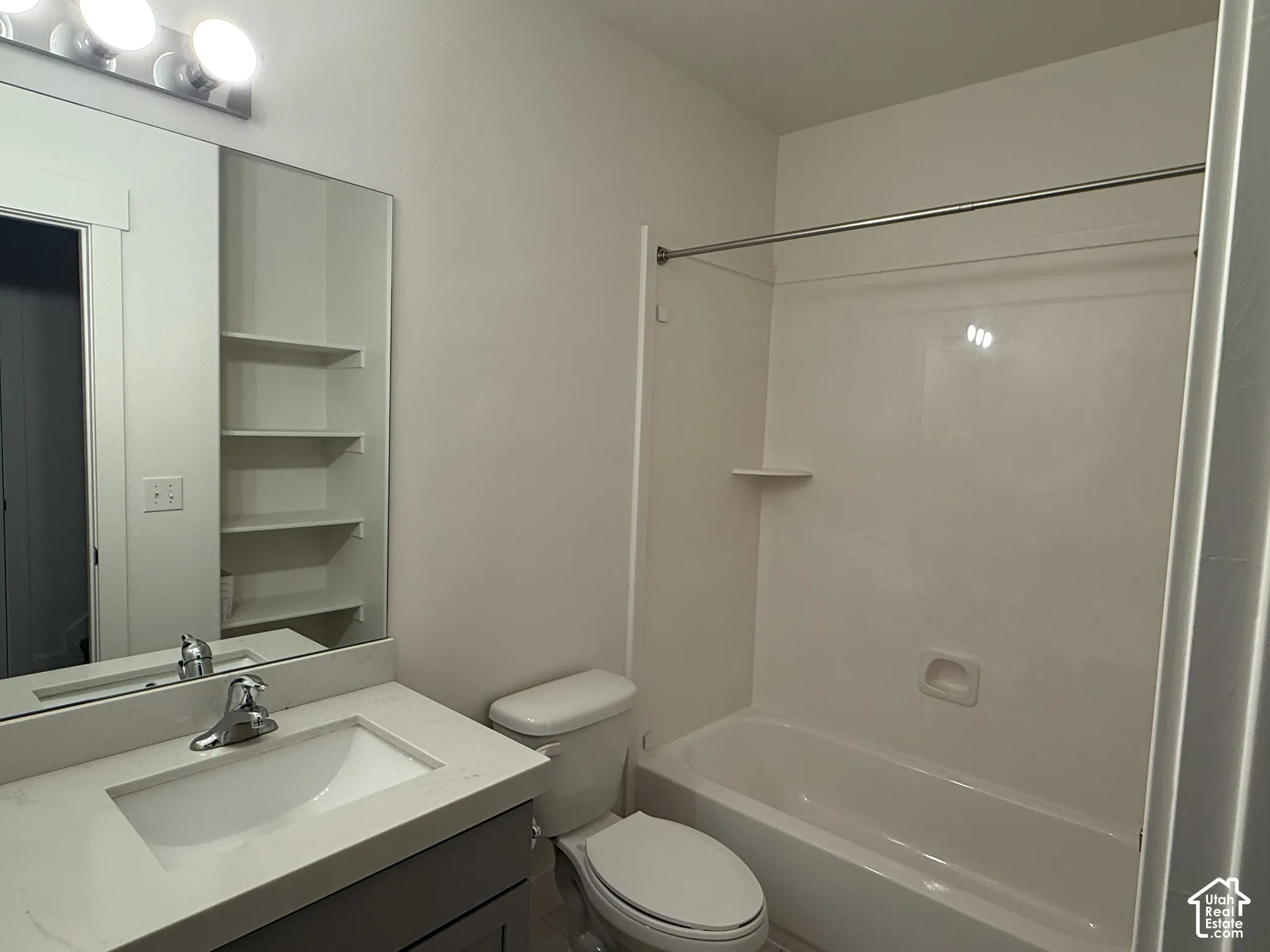 Bathroom featuring a vanity with a light-toned countertop, integrated sink, and chrome faucet