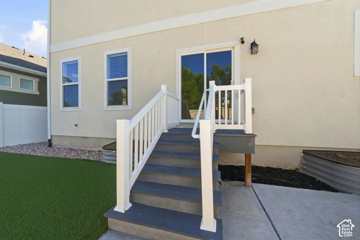 Stucco exterior with white trim, featuring a sliding glass door and two windows