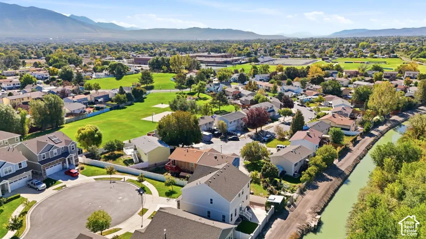 Neighborhood setting with mountain scenery, mature trees, and nearby green spaces