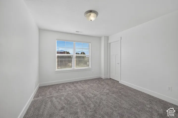 White walls complement gray carpeting, framed by white trim