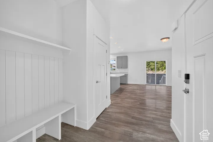 Entryway featuring a built-in bench with shiplap detailing and a storage shelf