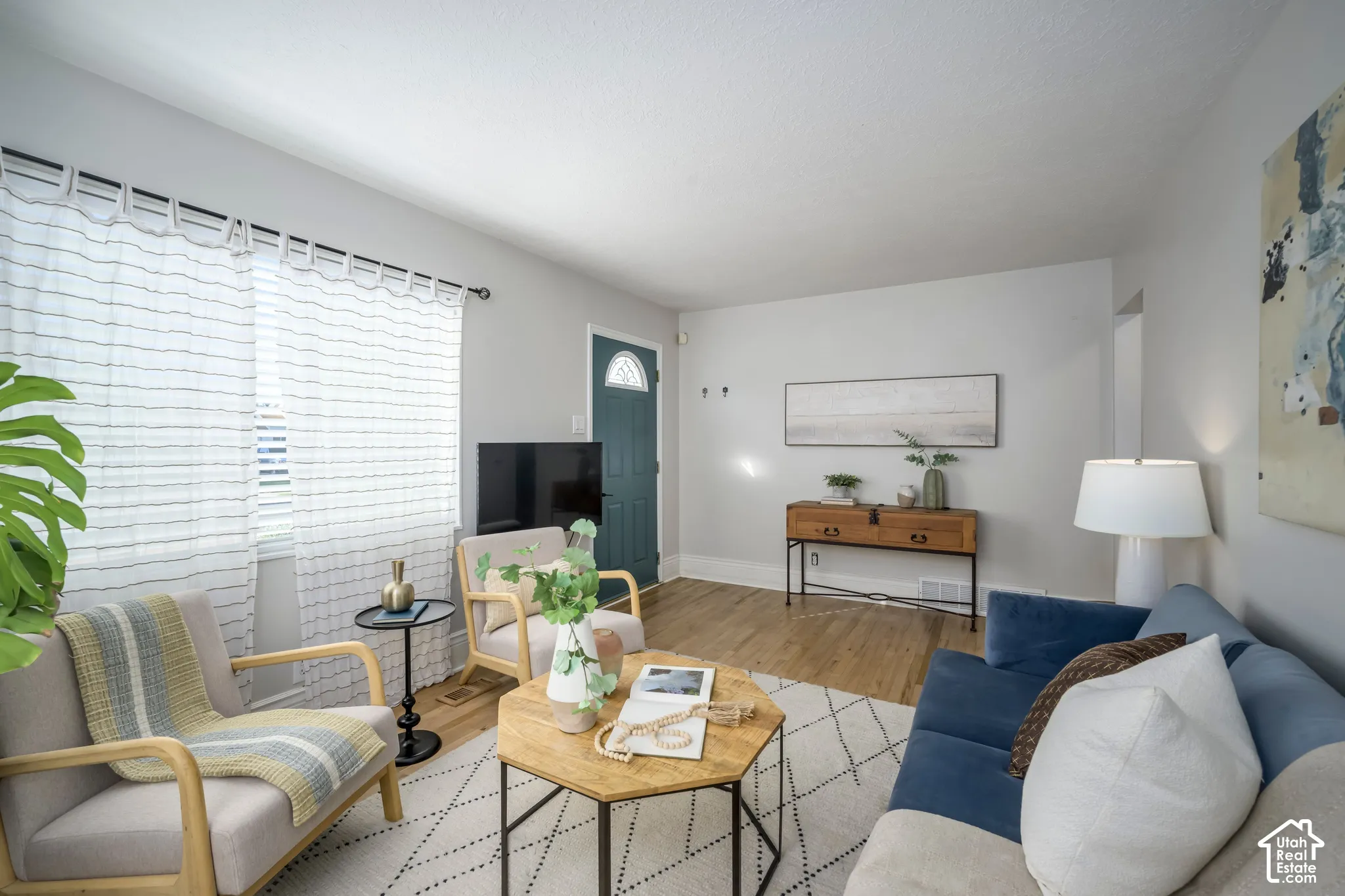 Light-toned walls, wood-finish flooring, and a semi-circular transom window on the entry door