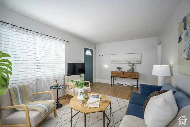 Light-toned walls, wood-finish flooring, and a semi-circular transom window on the entry door