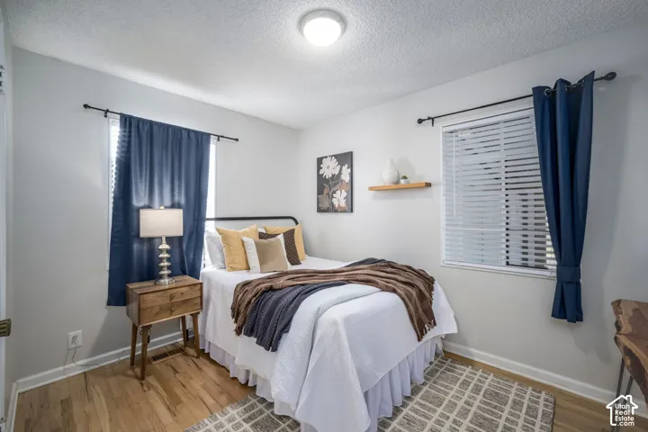 Wood-finish flooring with white baseboards