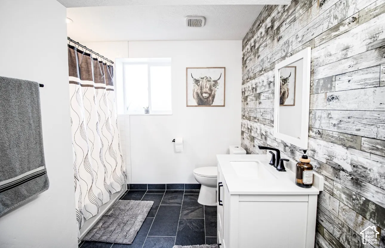 Vanity with integrated sink, matte black faucet, and white cabinetry
