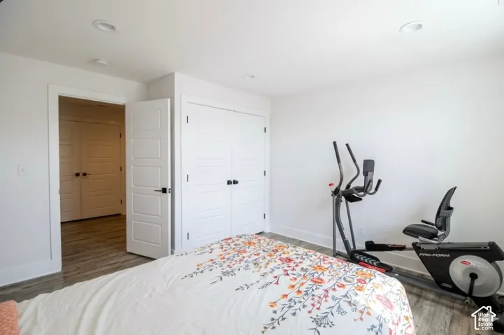 Recessed lighting, wood-finish flooring, white paneled doors, and matte black door hardware