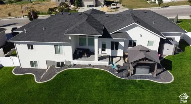 Modern stucco exterior with a dark shingle roof