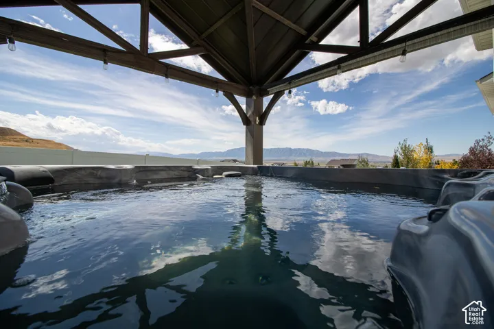 Covered outdoor spa with mountain scenery