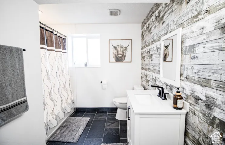 Vanity with integrated sink, matte black faucet, and white cabinetry