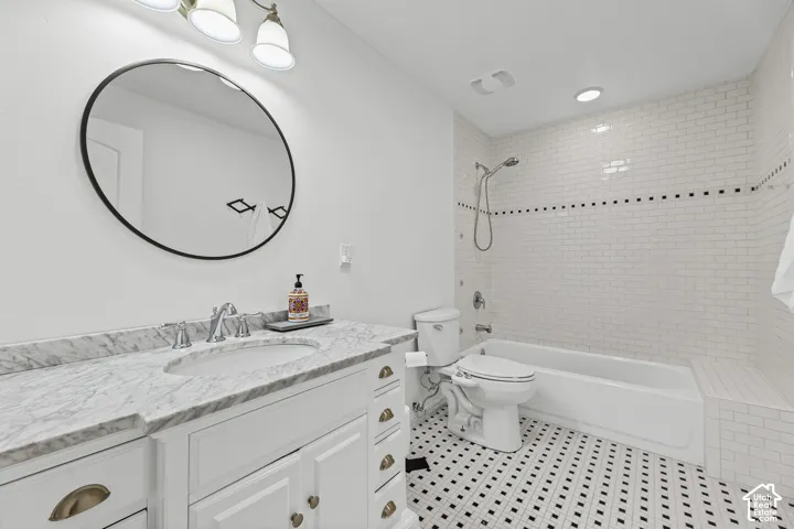White vanity with integrated sink and marble countertop