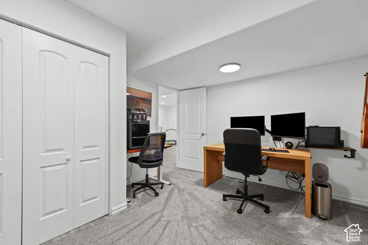 Room with light gray carpeting, recessed ceiling lighting, and white bi-fold closet doors