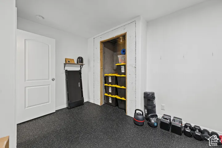 Rubberized flooring, built-in shelving, white door with silver hardware