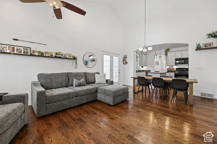 Vaulted ceiling, wood-finish flooring, ceiling fan, double French doors, recessed archway