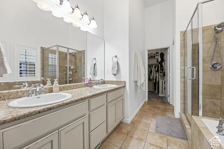 Dual vanity with granite-style countertop, integrated sinks, and polished chrome fixtures