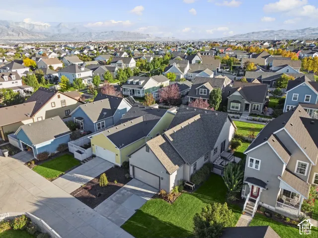 Residential neighborhood featuring varied architectural styles and mature landscaping, with distant mountain ranges