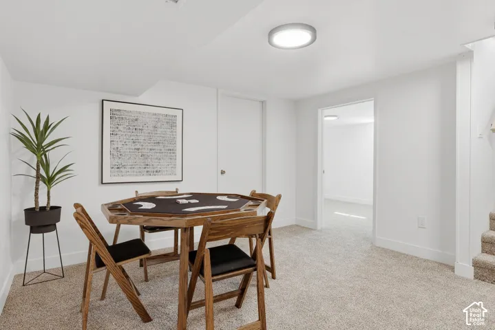 Carpeted flooring, white walls, flush mount ceiling lighting, and a white interior door