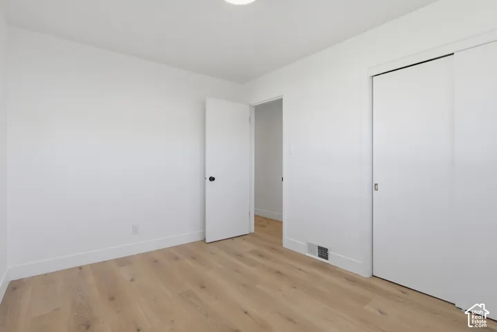 Light wood-finish flooring with white walls