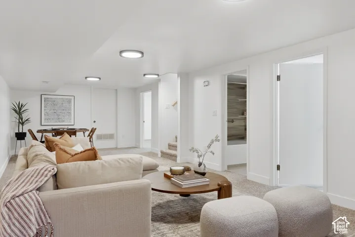 Carpeted flooring throughout, recessed ceiling lighting, white interior doors, and white painted walls
