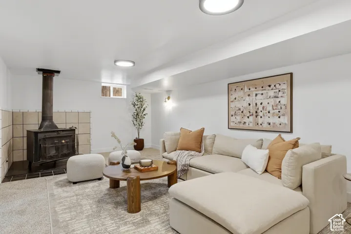 Integrated wood-burning stove with a tiled surround, recessed lighting, and a window