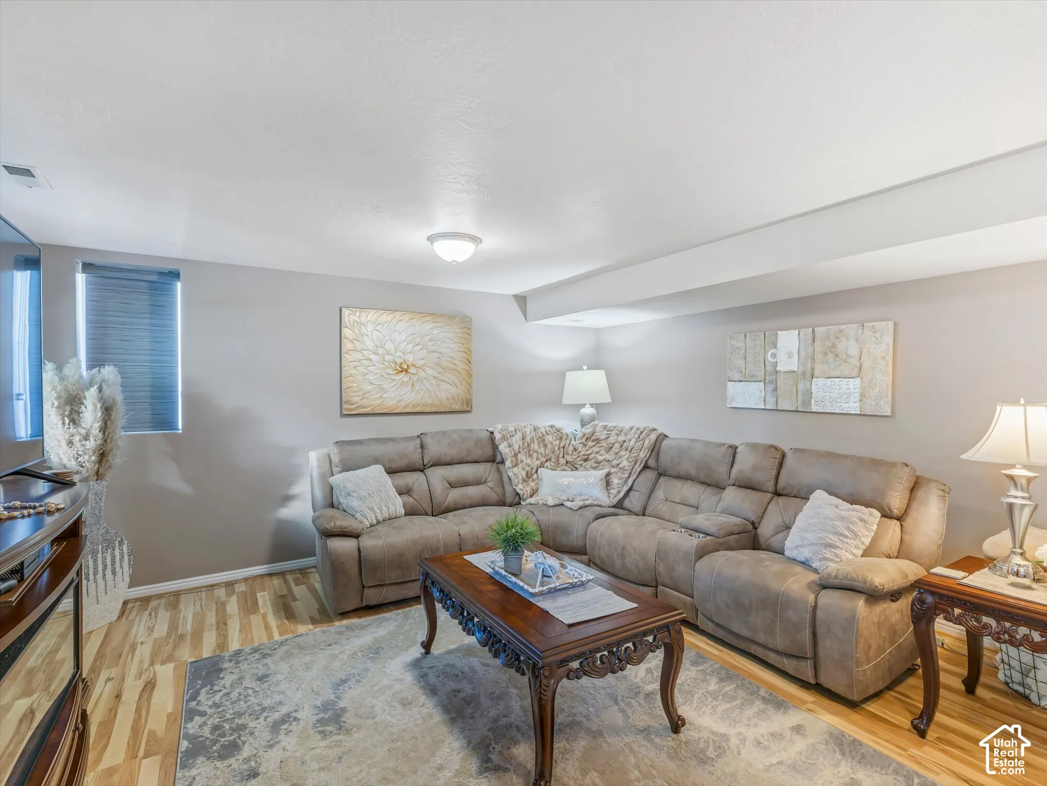 Recessed lighting, wood-finish flooring, and a window with blinds