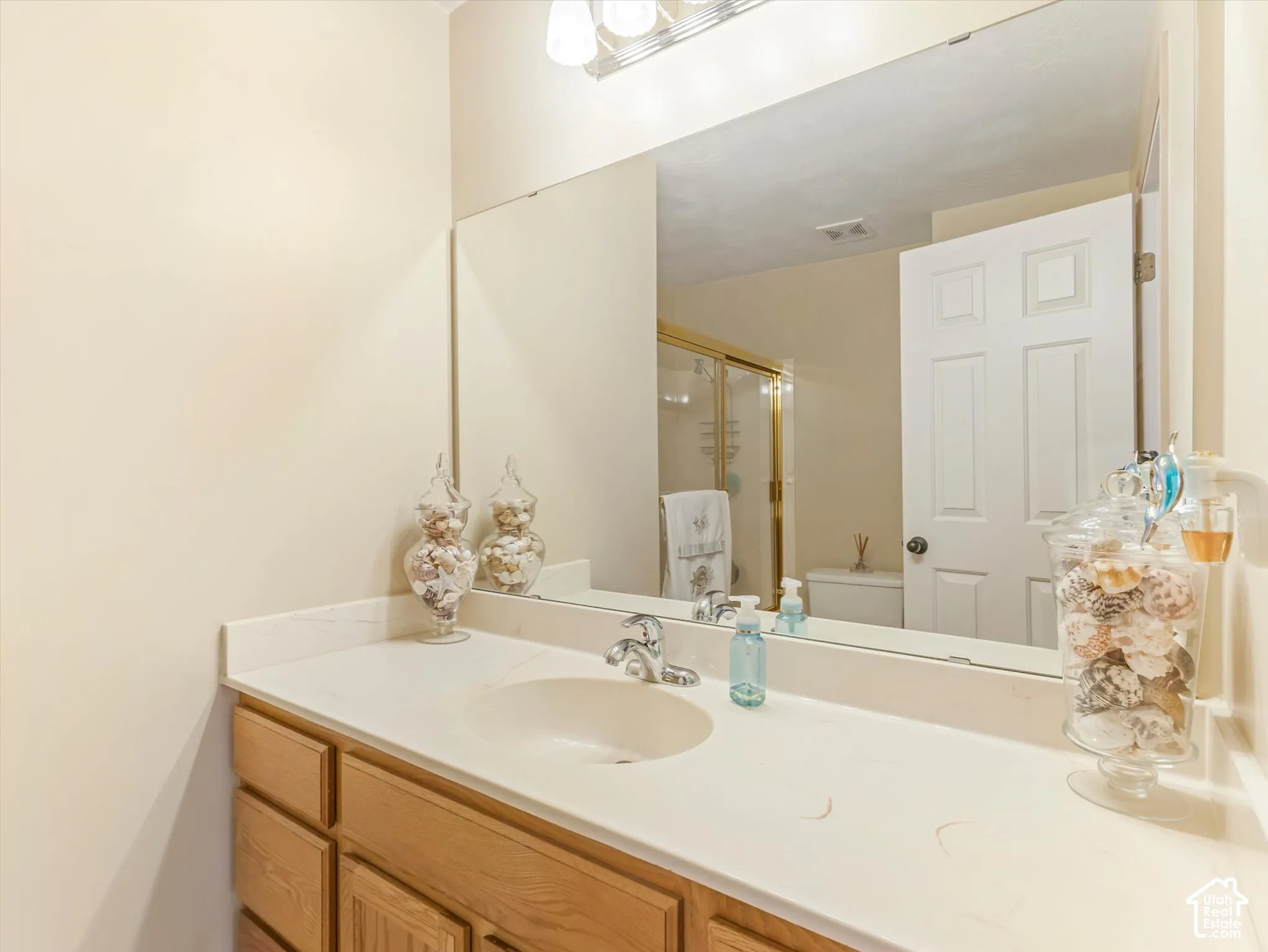 Vanity with a white countertop and an integrated sink basin