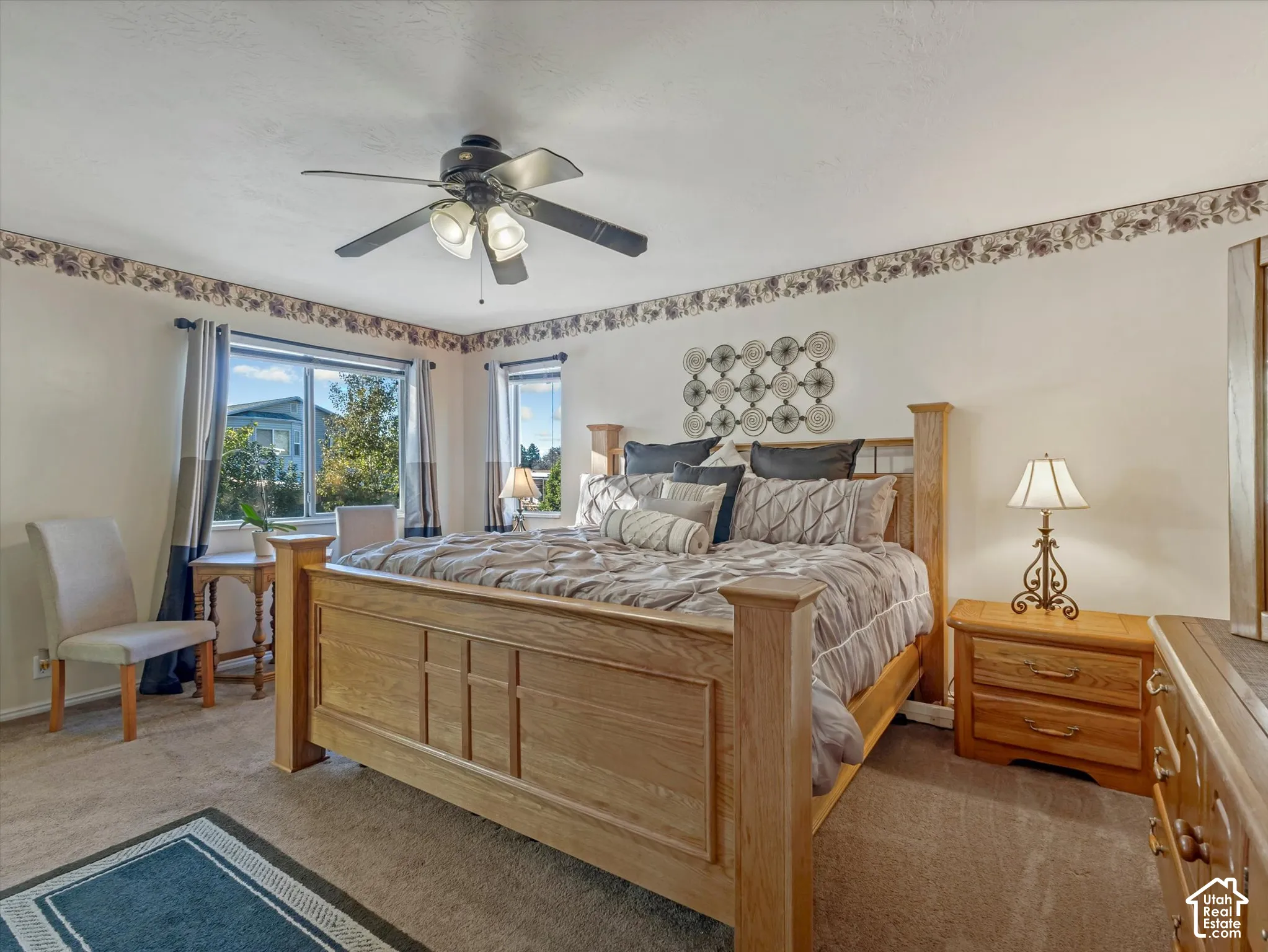 Recessed window with natural light, ceiling fan with integrated lighting, wall-to-wall carpeting, and neutral wall tones