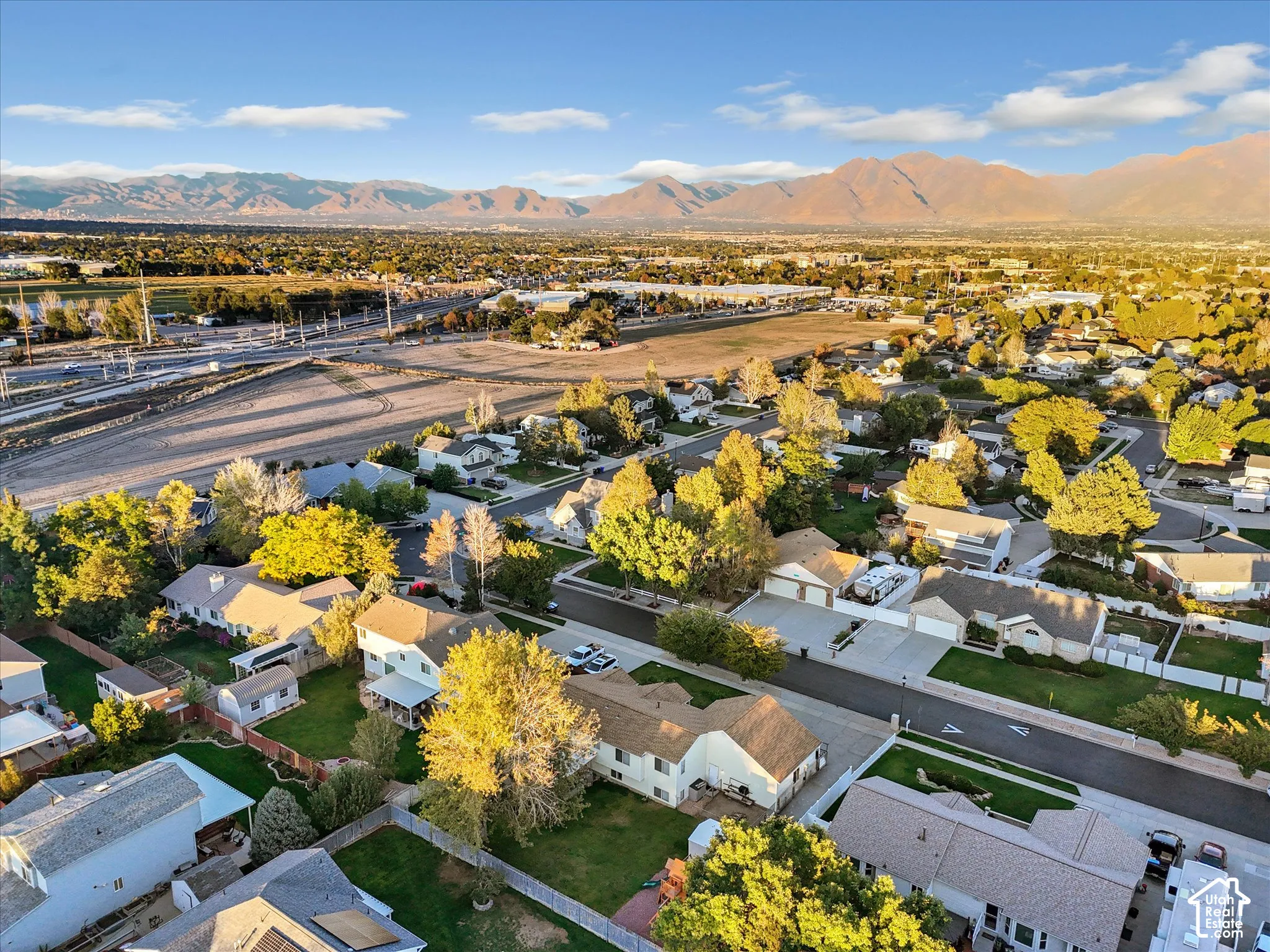 Expansive mountain range backdrop and a residential neighborhood with mature trees