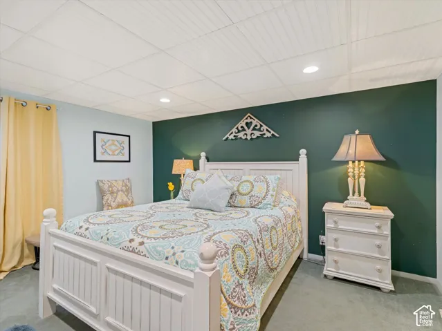 White beadboard ceiling, recessed lighting, and soft wall-to-wall carpeting
