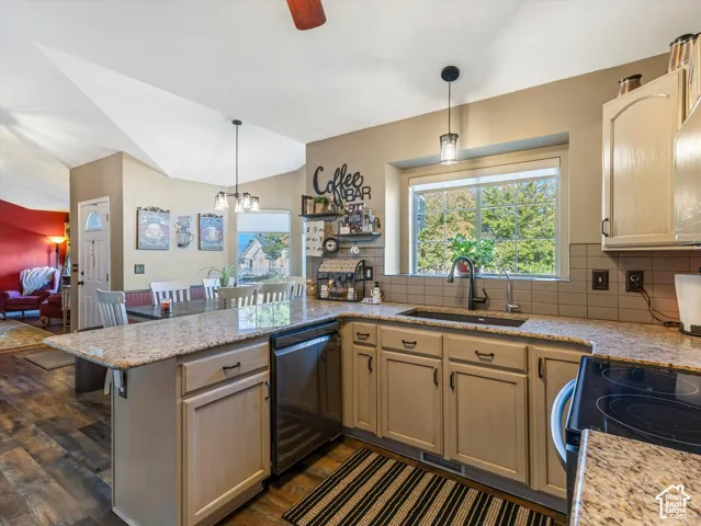 Kitchen featuring granite countertops, a built-in dishwasher, wood-finish flooring, and light-toned cabinetry