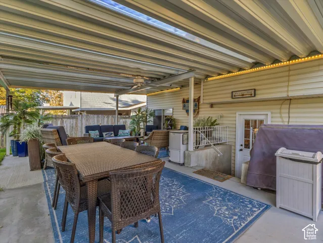 Covered patio featuring a ceiling fan, recessed lighting, and a white exterior door with glass paneling