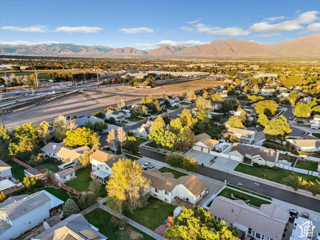 Expansive mountain range backdrop and a residential neighborhood with mature trees