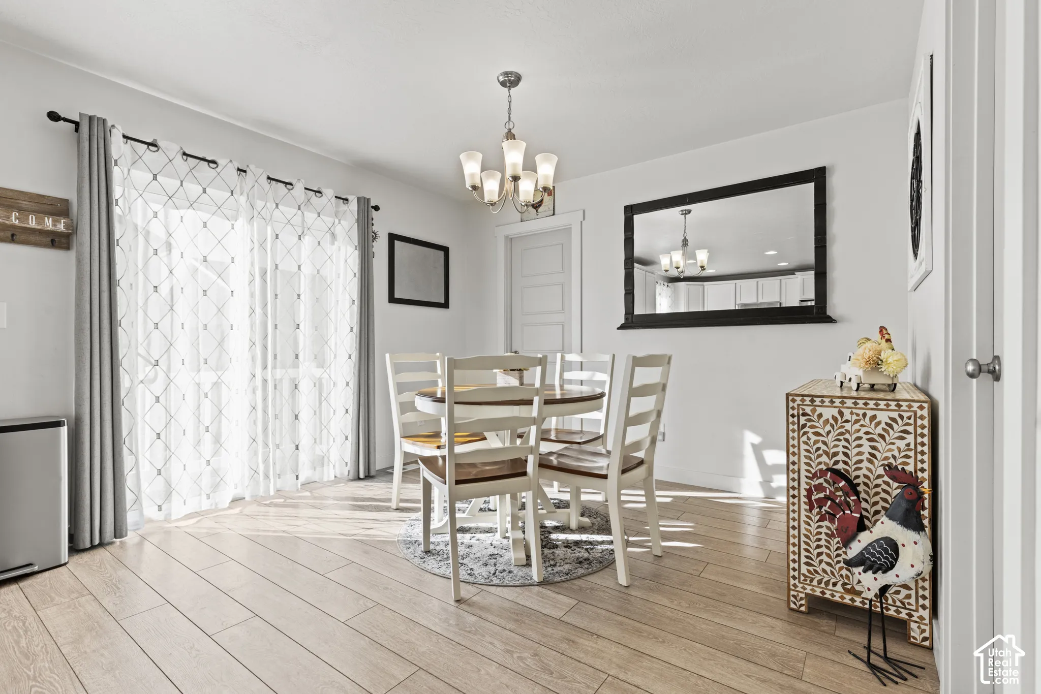 Recessed lighting, wood-finish flooring, and a decorative ceiling fixture