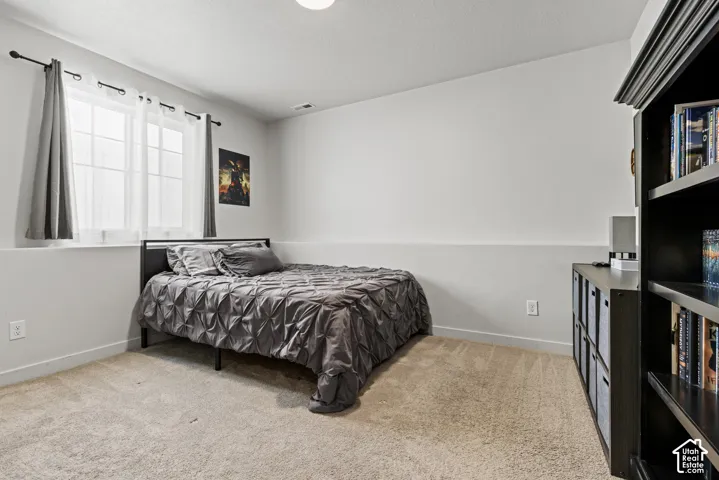 Room featuring carpet flooring, a window with white trim, and light gray walls