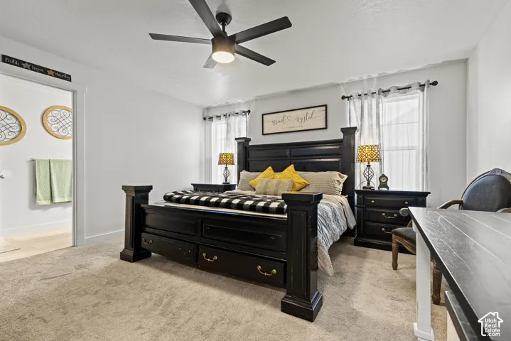 Soft carpeting, ceiling fan, and two windows with natural light