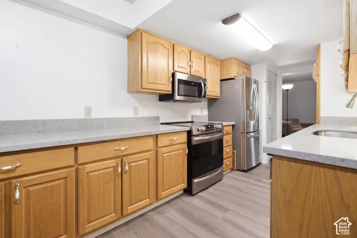 Wood-finish cabinetry with light gray countertops
