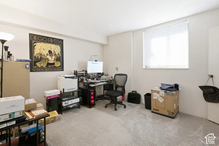 Recessed window with horizontal blinds, light gray wall paint, and gray carpeting