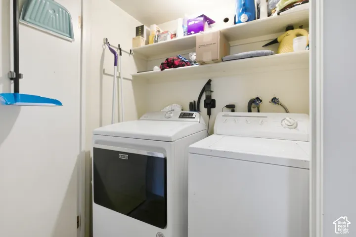Built-in shelving and appliance connections for a laundry area