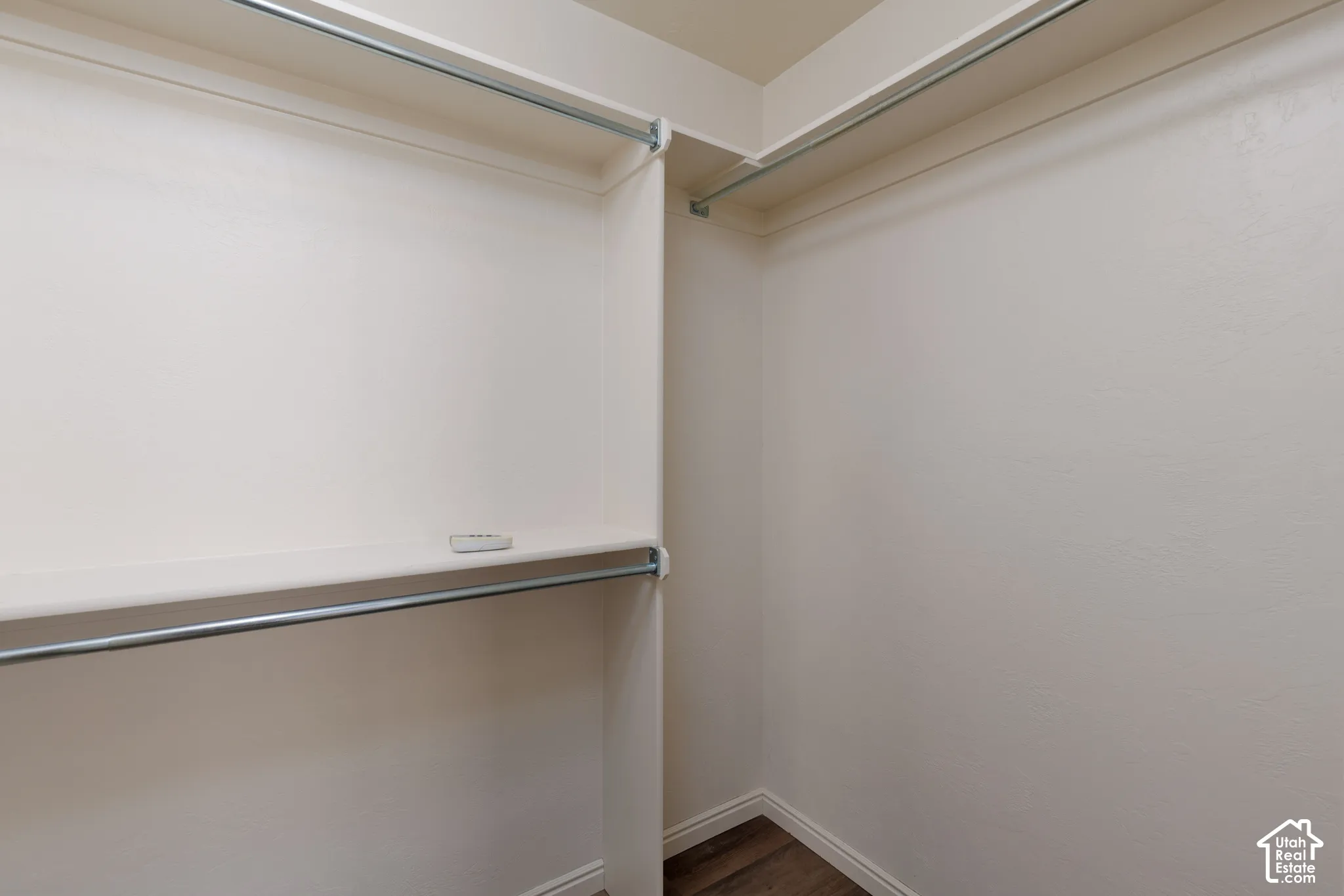 Walk-in closet with built-in shelving and dual hanging rods