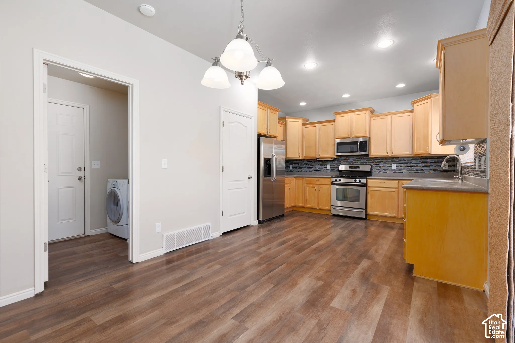 Kitchen featuring wood-finish flooring, recessed lighting, and stainless steel appliances