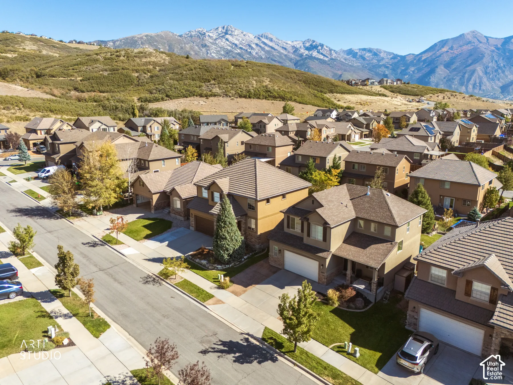 Residential community with mountain backdrop, paved streets, and sidewalks