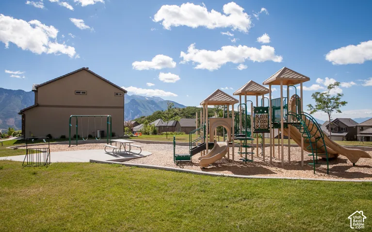 Community playground with multiple slides, swing set, and picnic area