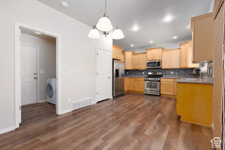 Kitchen featuring wood-finish flooring, recessed lighting, and stainless steel appliances