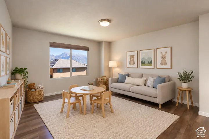 Bright room with wood-finish flooring, a large window, recessed lighting, and a neutral wall color
