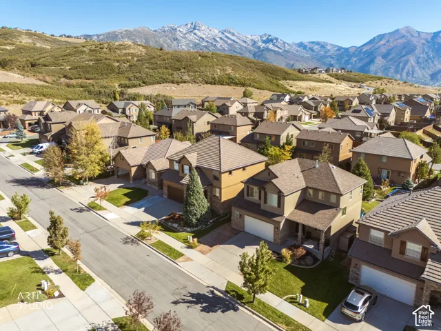 Residential community with mountain backdrop, paved streets, and sidewalks