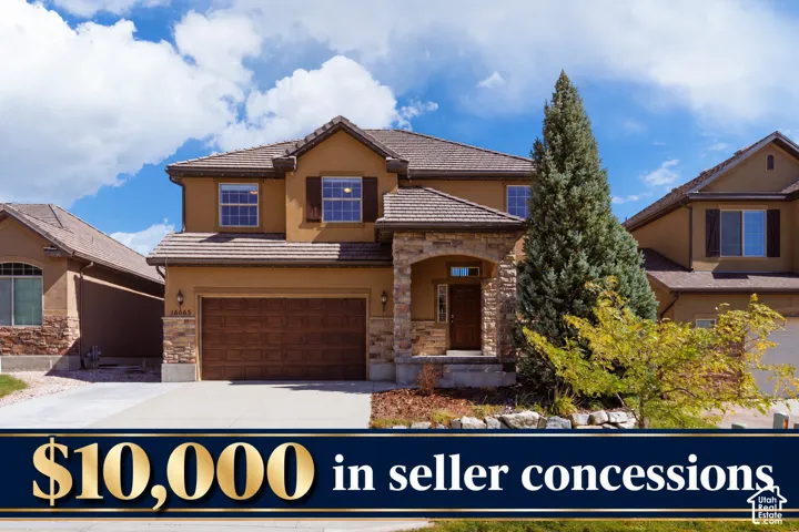 Stucco exterior with stone accents, attached two-car garage, covered entry, and mature landscaping