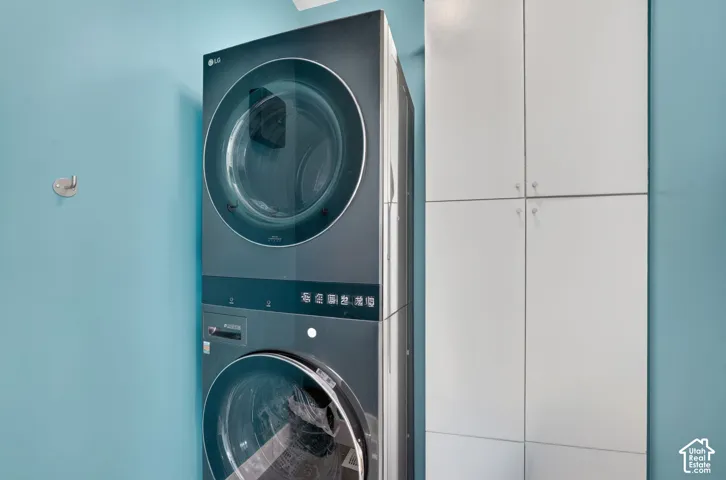 Modern laundry center featuring two stacked LG front-load washers and dryers with large-capacity drums and digital control panels