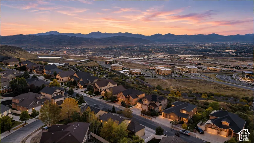 Residential neighborhood with paved streets and established homes, set against a mountain backdrop