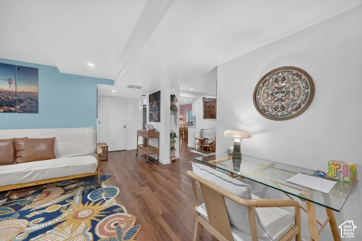 Wood-finish flooring throughout, white walls, and recessed lighting
