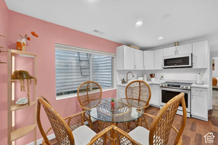 Kitchenette with white shaker cabinetry, stainless steel appliances, a white solid surface countertop, and recessed lighting
